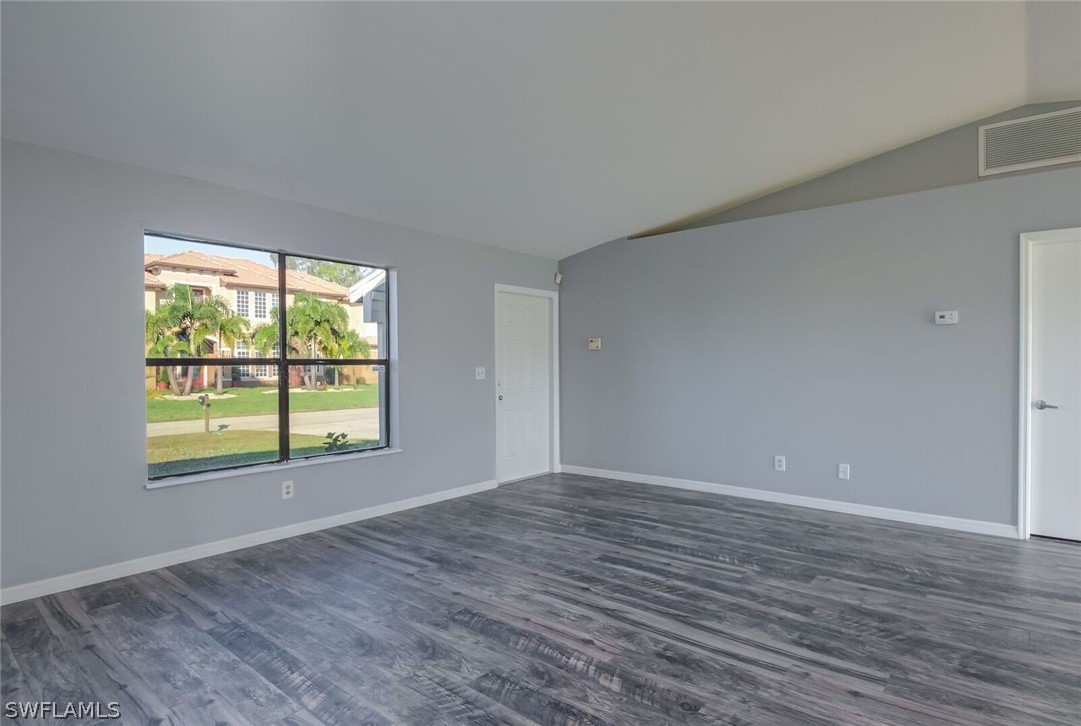 18485 Sebring Road Fort Myers, FL 33967 - Photo 6 of 21 a view of an empty room with wooden floor and a window