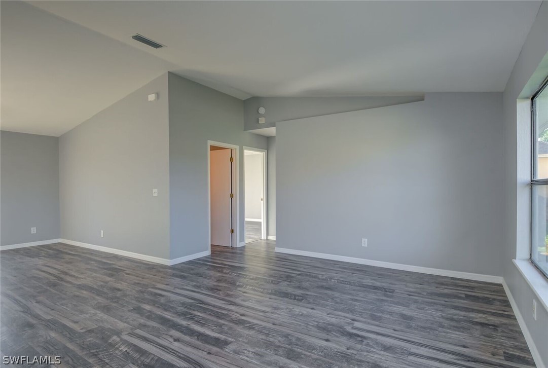 18485 Sebring Road Fort Myers, FL 33967 - Photo 7 of 21 a view of an empty room with wooden floor and closet