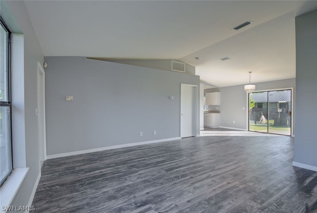 18485 Sebring Road Fort Myers, FL 33967 - Photo 8 of 21 a view of an empty room with wooden floor and a window