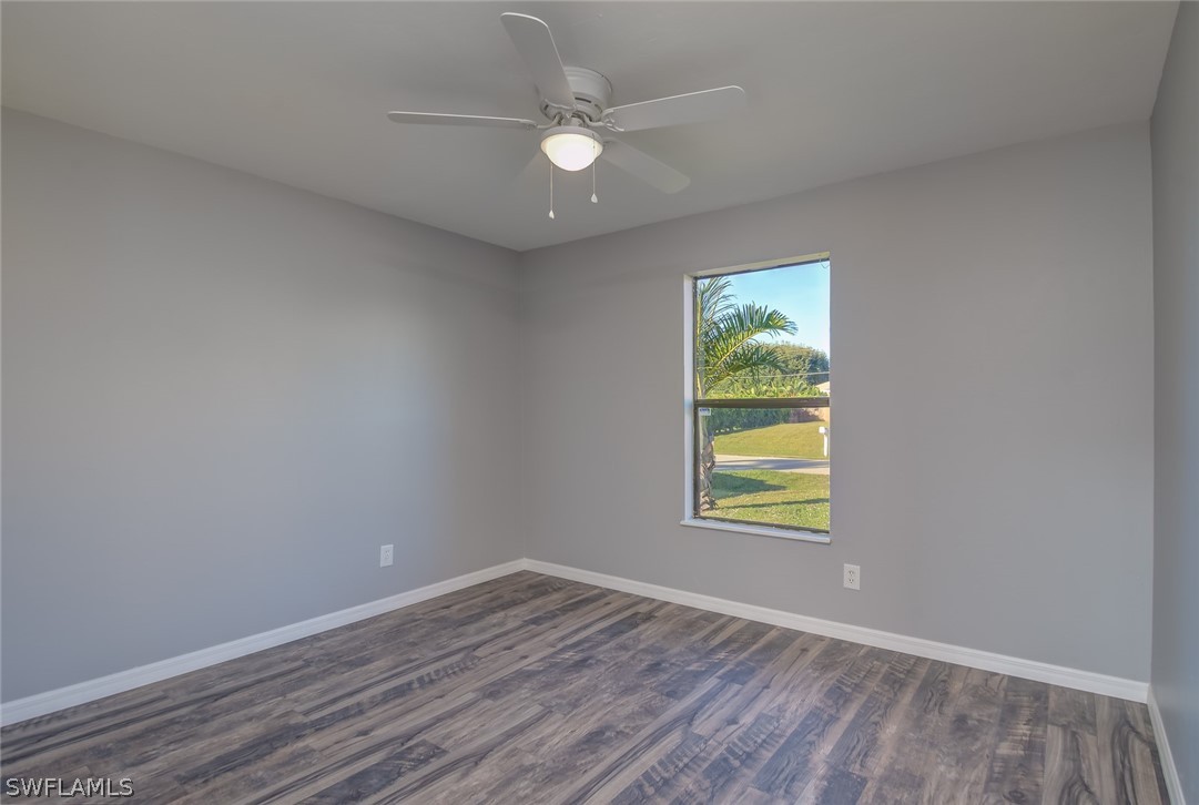 18485 Sebring Road Fort Myers, FL 33967 - Photo 9 of 21 an empty room with window and ceiling fan