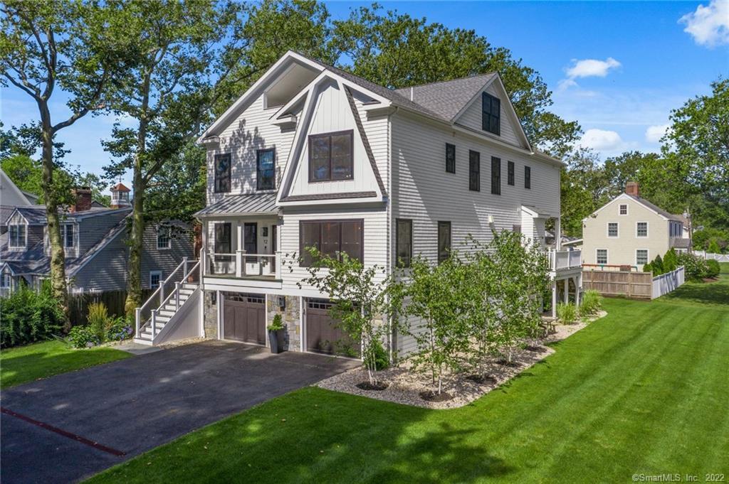 12 Puritan Road Fairfield, CT 06824 - Photo 1 of 1 a front view of a house with a yard