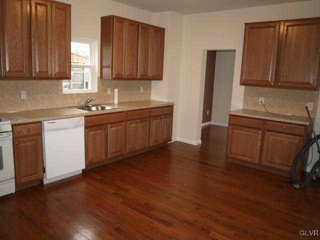 702 Spring Street Bethlehem, PA 18018 - Photo 2 of 17 a kitchen with stainless steel appliances granite countertop a sink a stove a refrigerator cabinets and wooden floor