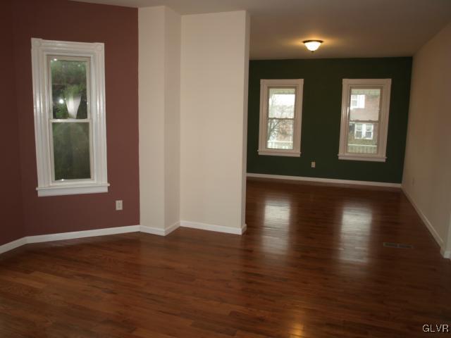 702 Spring Street Bethlehem, PA 18018 - Photo 3 of 17 a view of an empty room with wooden floor and a window
