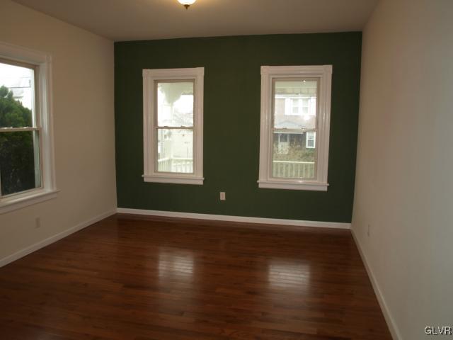 702 Spring Street Bethlehem, PA 18018 - Photo 5 of 17 an empty room with wooden floor and windows