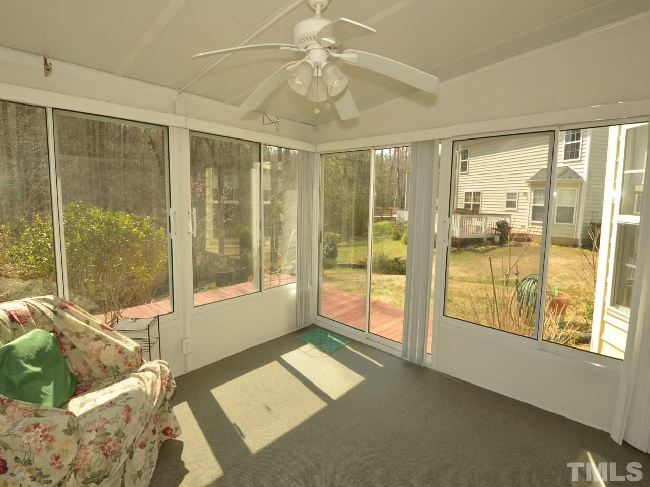 335 Inkster Cove Raleigh, NC 27603 - Photo 13 of 25 a living room with couch and a floor to ceiling window