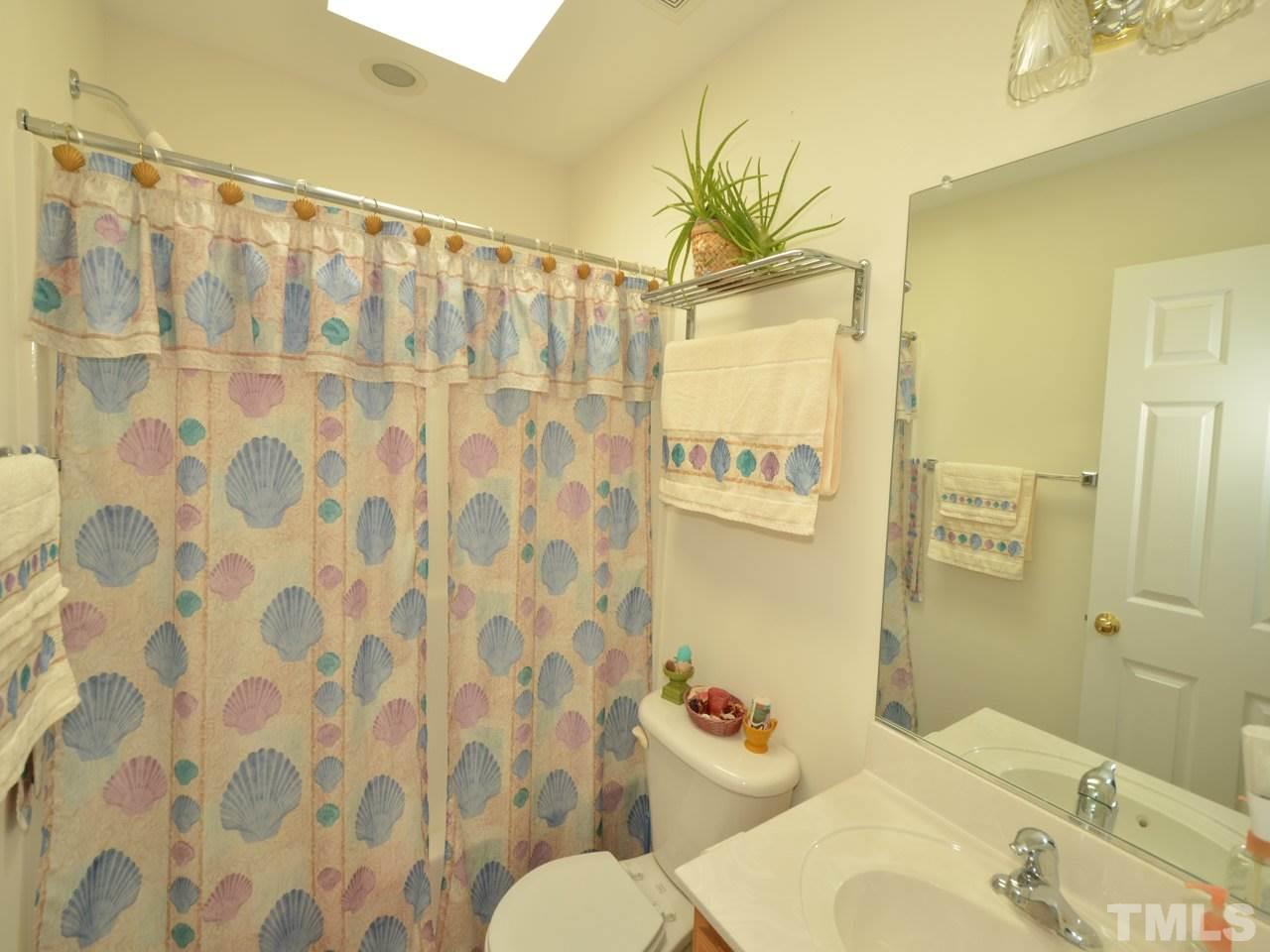 335 Inkster Cove Raleigh, NC 27603 - Photo 18 of 25 a bathroom with a sink toilet and shower