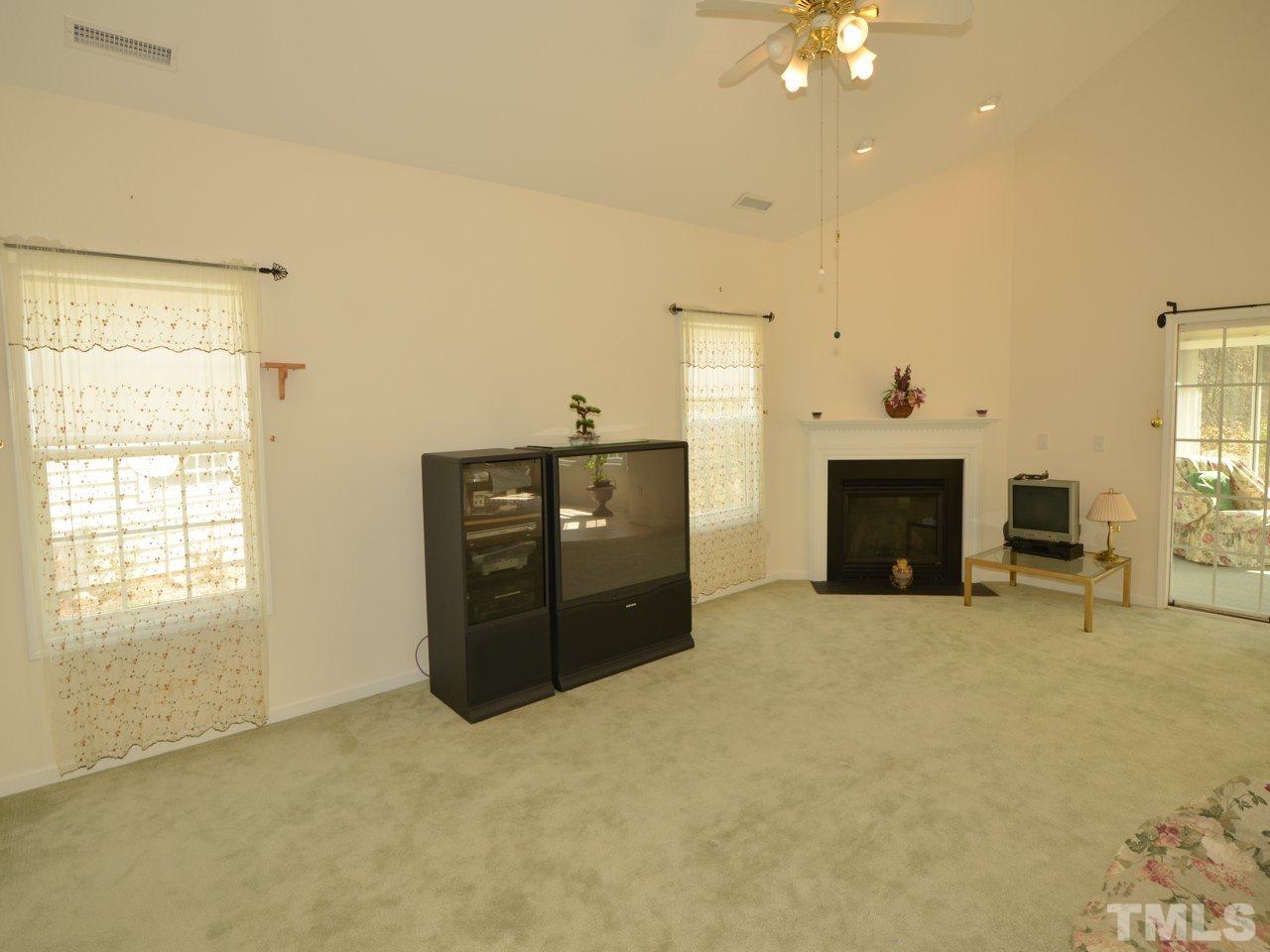 335 Inkster Cove Raleigh, NC 27603 - Photo 4 of 25 an empty room with furniture and fireplace