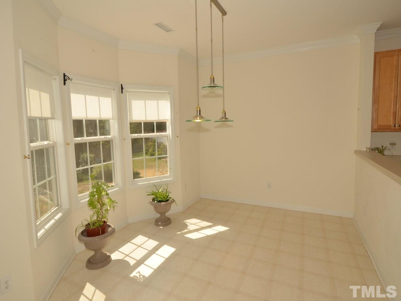 335 Inkster Cove Raleigh, NC 27603 - Photo 6 of 25 a view of entryway with a flower pot and a window