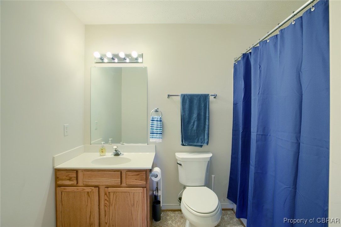 118 Edwards Court Dutton, VA 23050 - Photo 22 of 24 Bathroom with vanity, toilet, and a shower with shower curtain