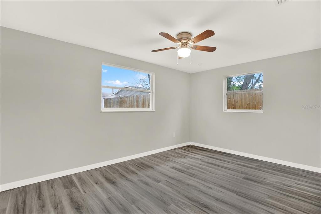 5038 Galaxy Drive New Port Richey, FL 34652 - Photo 12 of 32 a view of an empty room with wooden floor and window