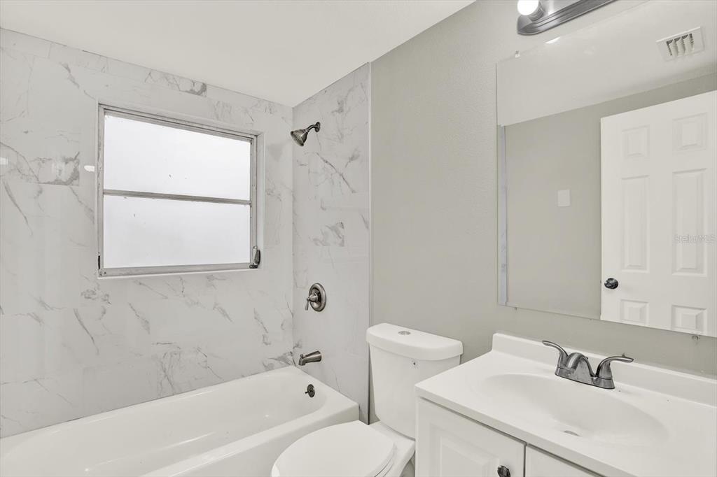 5038 Galaxy Drive New Port Richey, FL 34652 - Photo 16 of 32 a bathroom with a sink toilet and shower