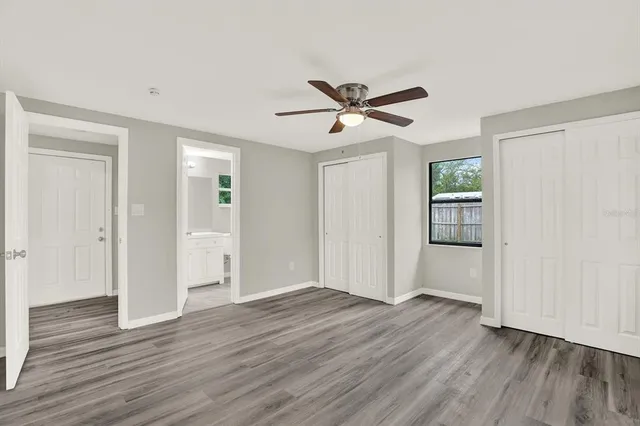 a view of empty room with wooden floor