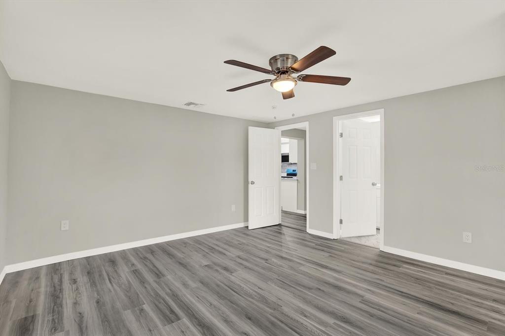 5038 Galaxy Drive New Port Richey, FL 34652 - Photo 19 of 32 an empty room with wooden floor and windows