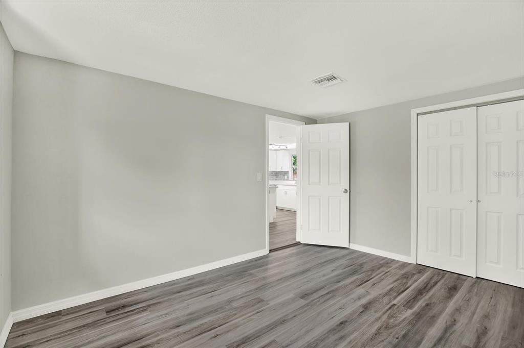 5038 Galaxy Drive New Port Richey, FL 34652 - Photo 22 of 32 a view of an empty room with wooden floor