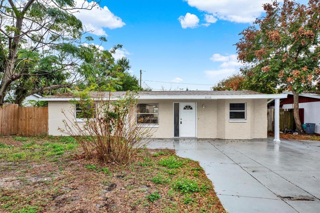 5038 Galaxy Drive New Port Richey, FL 34652 - Photo 25 of 32 a view of a house with a yard