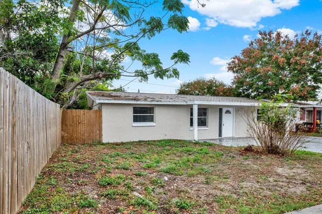 a house that has a tree in front of it