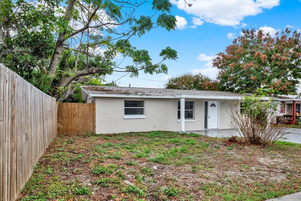 5038 Galaxy Drive New Port Richey, FL 34652 - Photo 26 of 32 a house that has a tree in front of it