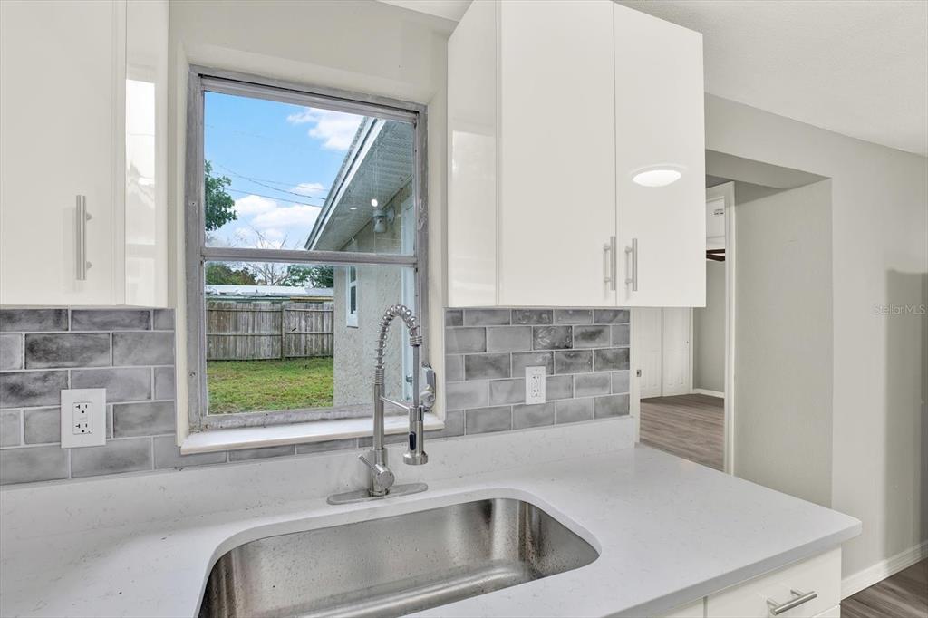 5038 Galaxy Drive New Port Richey, FL 34652 - Photo 7 of 32 a kitchen with a sink and a window