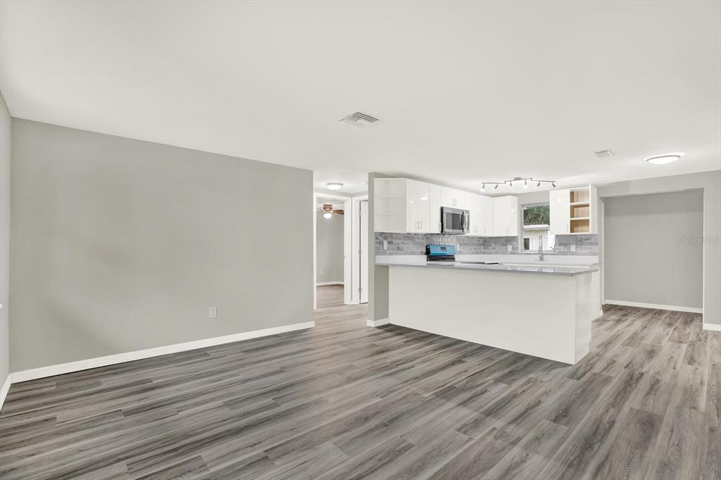 5038 Galaxy Drive New Port Richey, FL 34652 - Photo 9 of 32 a view of kitchen with wooden floor