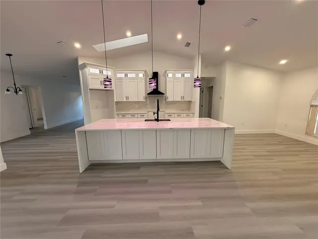 a large kitchen with stainless steel appliances kitchen island a large island in the center