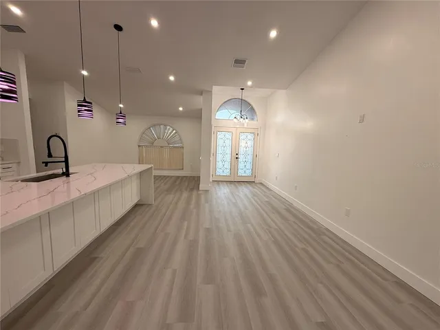 a large room with wooden floor and windows