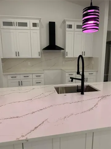 a kitchen with a sink cabinets and appliances