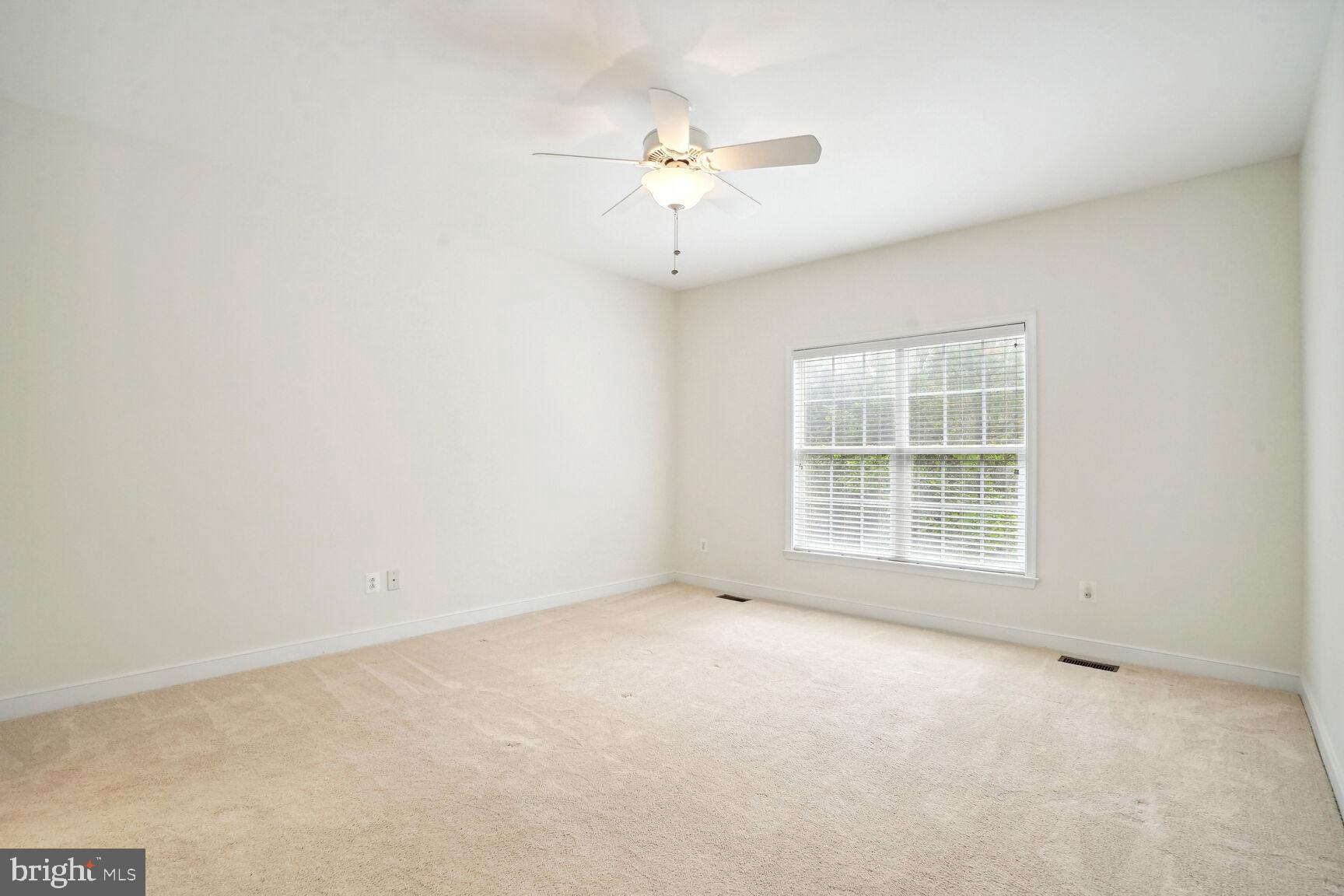 13037 Ormond Drive Bristow, VA 20136 - Photo 14 of 36 Primary bedroom windows overlook back yard patio.