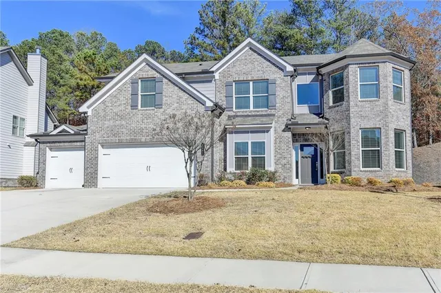 a front view of a house with a yard