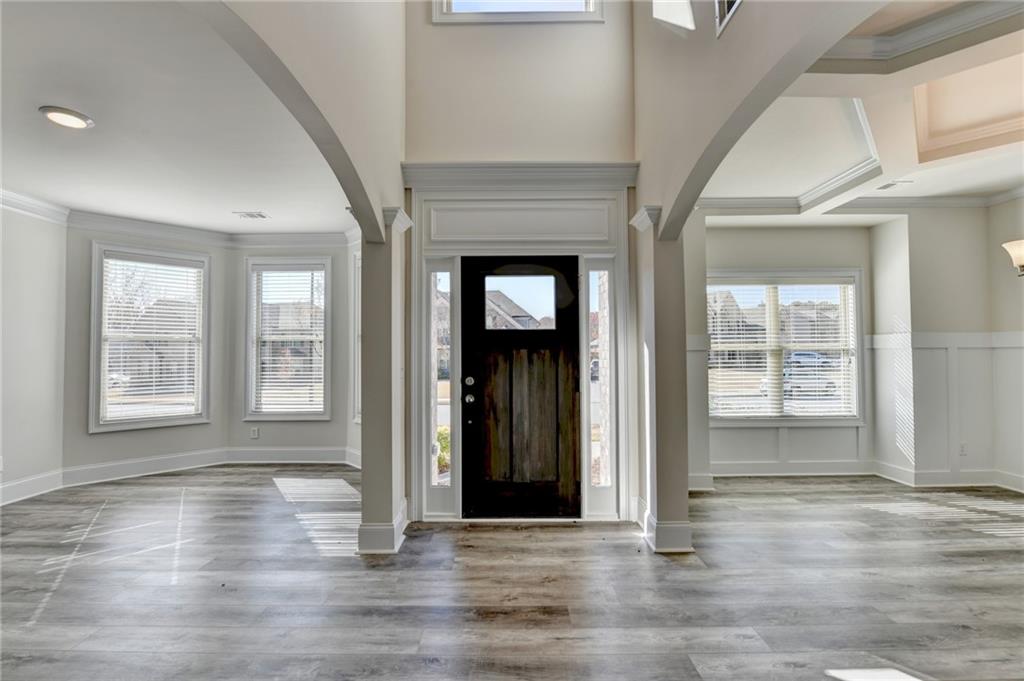 1661 Silver Crest Way Hoschton, GA 30548 - Photo 3 of 57 an empty room with wooden floor and windows