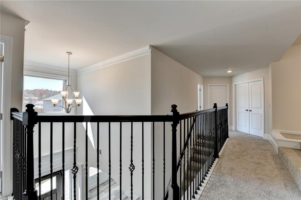 1661 Silver Crest Way Hoschton, GA 30548 - Photo 32 of 57 a view of hallway with wooden floor
