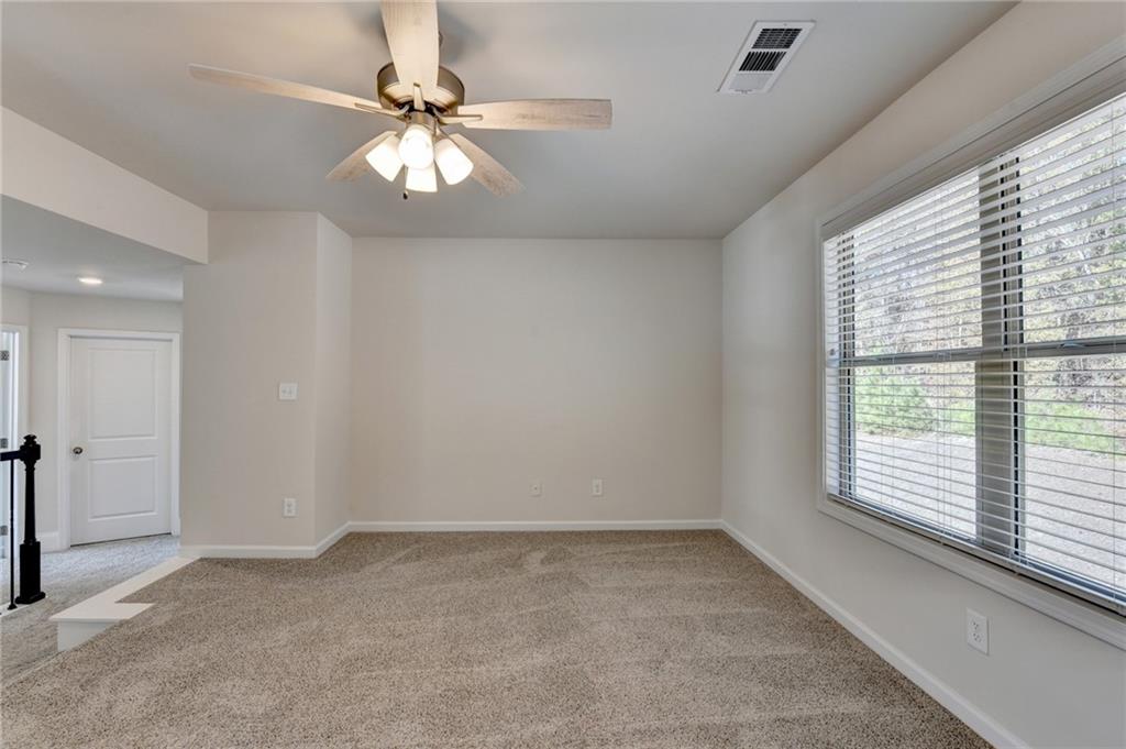 1661 Silver Crest Way Hoschton, GA 30548 - Photo 39 of 57 a view of an empty room with a window