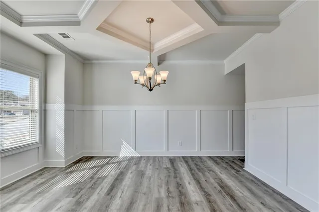 a view of a room with wooden floor and chandelier
