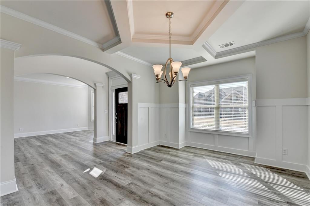 1661 Silver Crest Way Hoschton, GA 30548 - Photo 7 of 57 a view of an empty room with a window