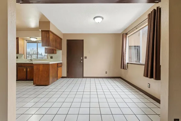a room with a washing machine and cabinets