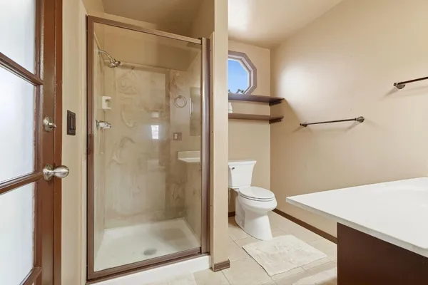 a bathroom with a shower and a toilet