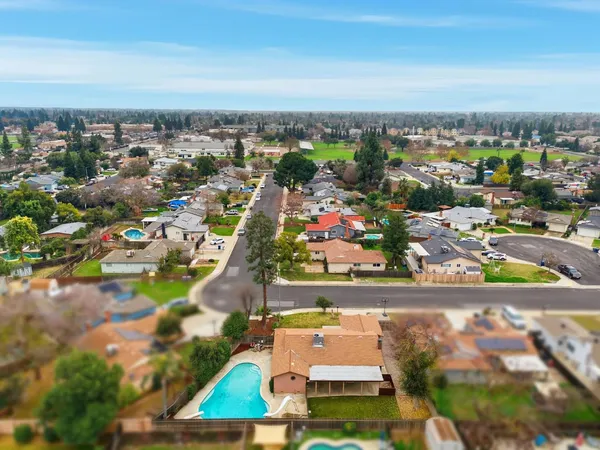 an aerial view of a house with a swimming pool