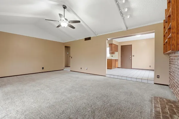 a view of a livingroom with a ceiling fan and window