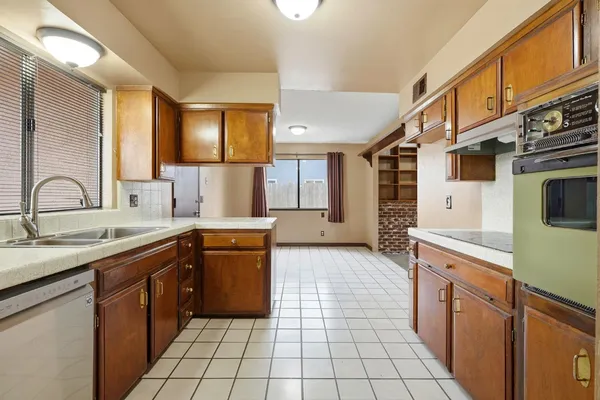 a kitchen with a sink stove and cabinets