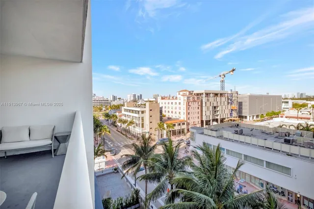 a view of a balcony with furniture and city view