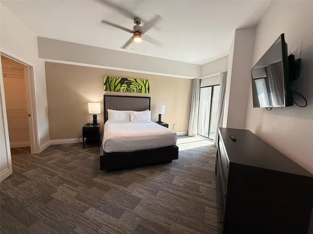 a bedroom with a bed and a flat screen tv