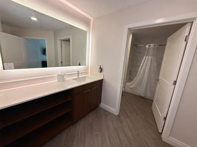 a bathroom with a sink a mirror and a shower