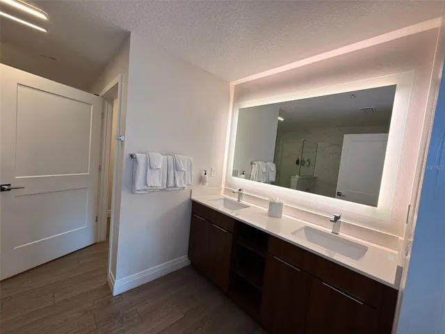 a bathroom with a double vanity sink and mirror