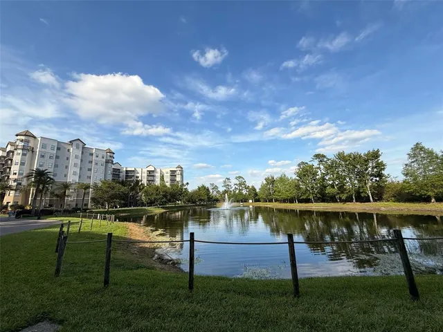 a view of house with outdoor space and lake view