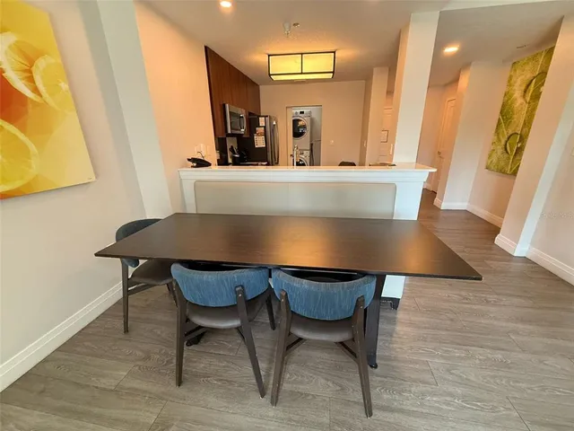 a view of a dining room with furniture and wooden floor
