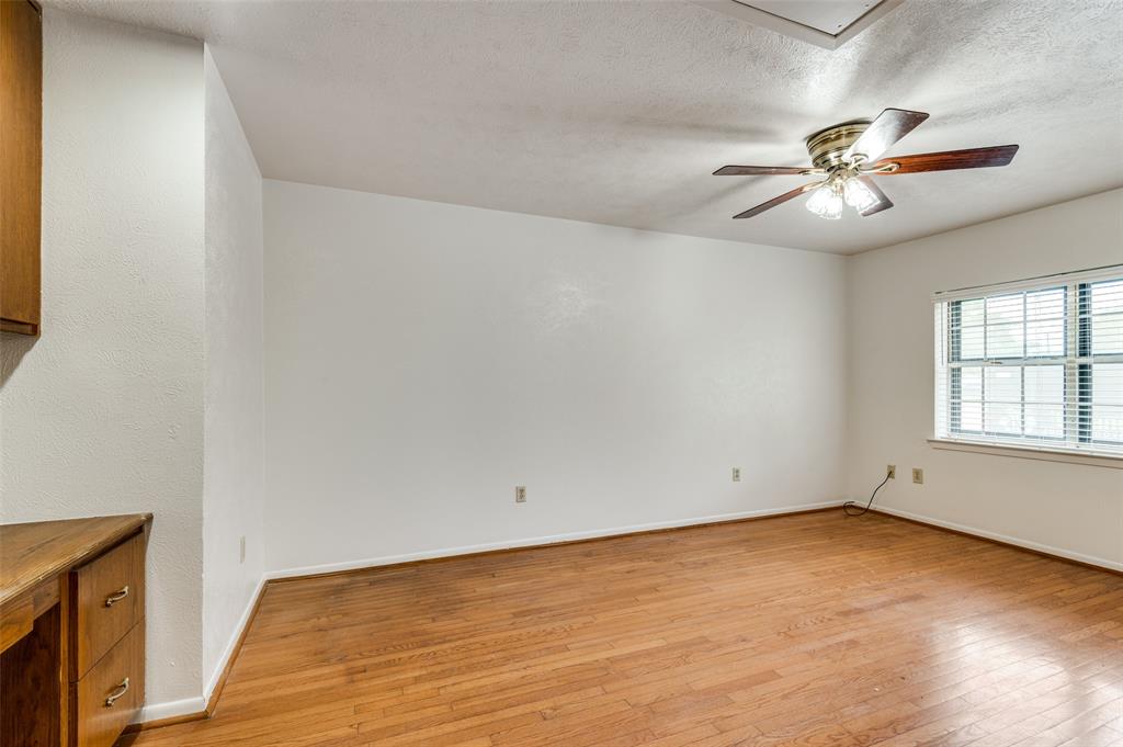 1230 Fairdale Street Irving, TX 75062 - Photo 11 of 24 Unfurnished room featuring light wood finished floors, a textured ceiling, and a ceiling fan