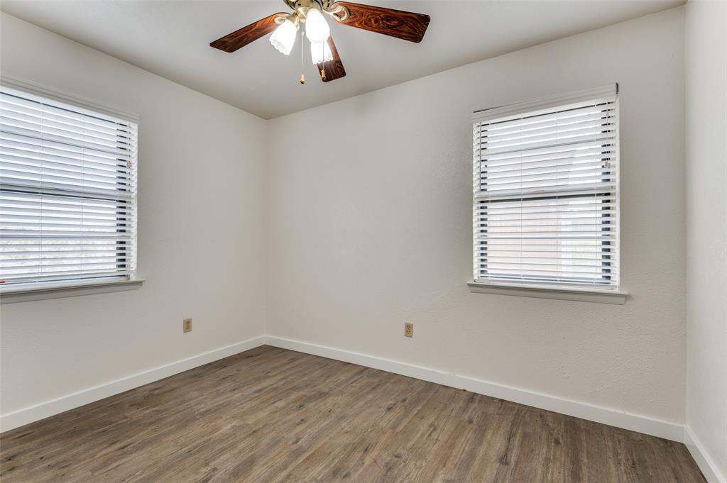 1230 Fairdale Street Irving, TX 75062 - Photo 16 of 24 Spare room with dark wood-style flooring, plenty of natural light, and ceiling fan