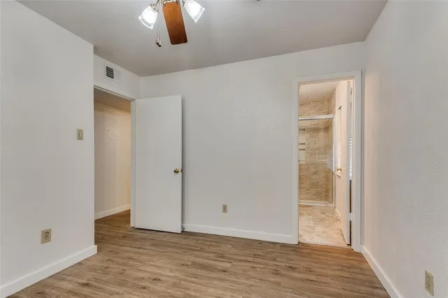 a view of an empty room and wooden floor