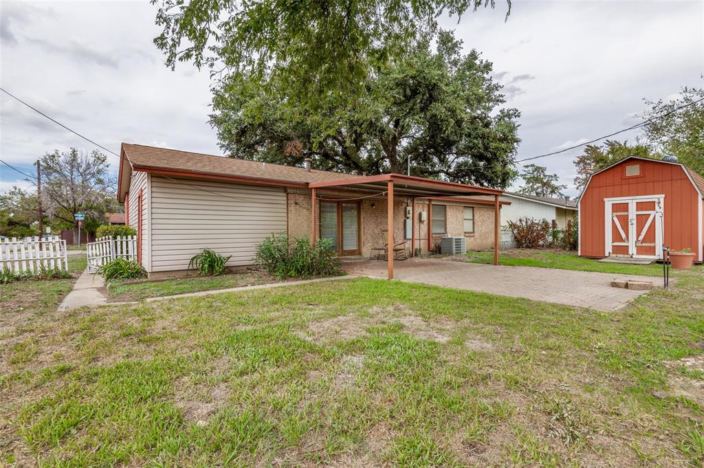 1230 Fairdale Street Irving, TX 75062 - Photo 2 of 24 Back of house featuring a storage unit and a patio