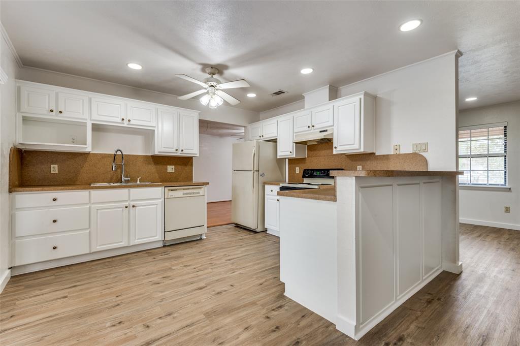 1230 Fairdale Street Irving, TX 75062 - Photo 5 of 24 Kitchen featuring tasteful backsplash, white cabinets, white appliances, recessed lighting, and light wood-style floors