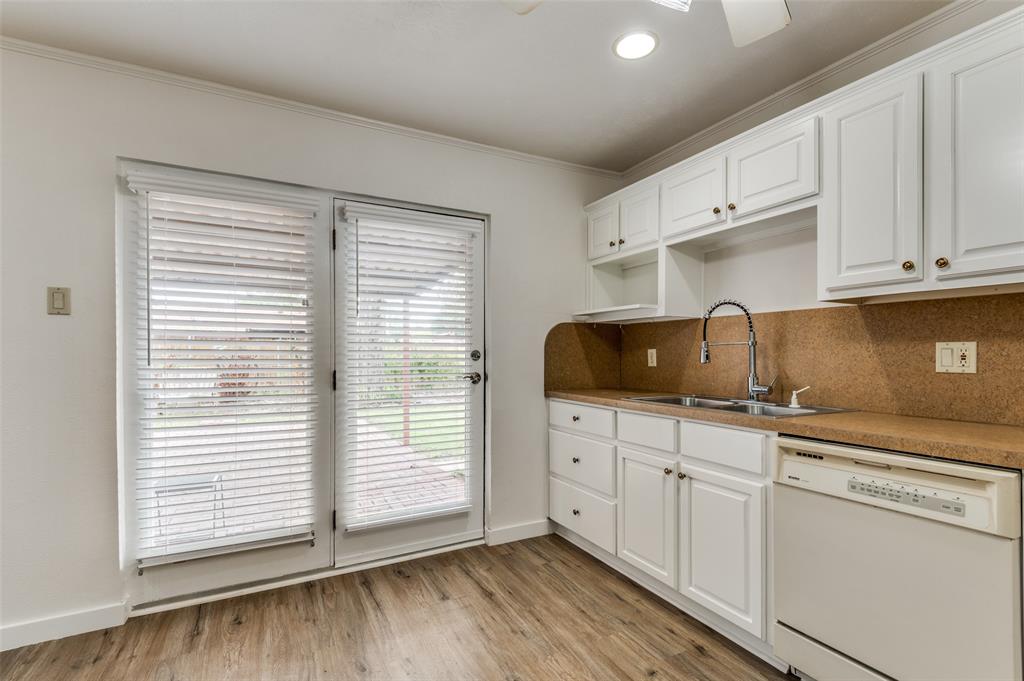 1230 Fairdale Street Irving, TX 75062 - Photo 10 of 24 Kitchen with dishwasher, white cabinets, decorative backsplash, light wood-style flooring, and ornamental molding